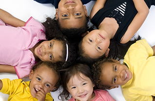 Six students pose with their heads together