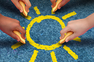 Students drawing a sun with chalk