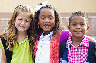 Three students pose outside