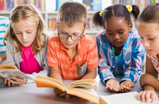 Four students read books in a library