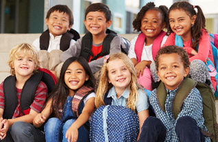 Students wearing backpacks pose together