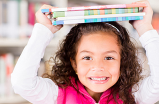 Female students holds books on her head